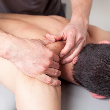 Man Receiving Massage Therapy on His Knotted Neck Service Box